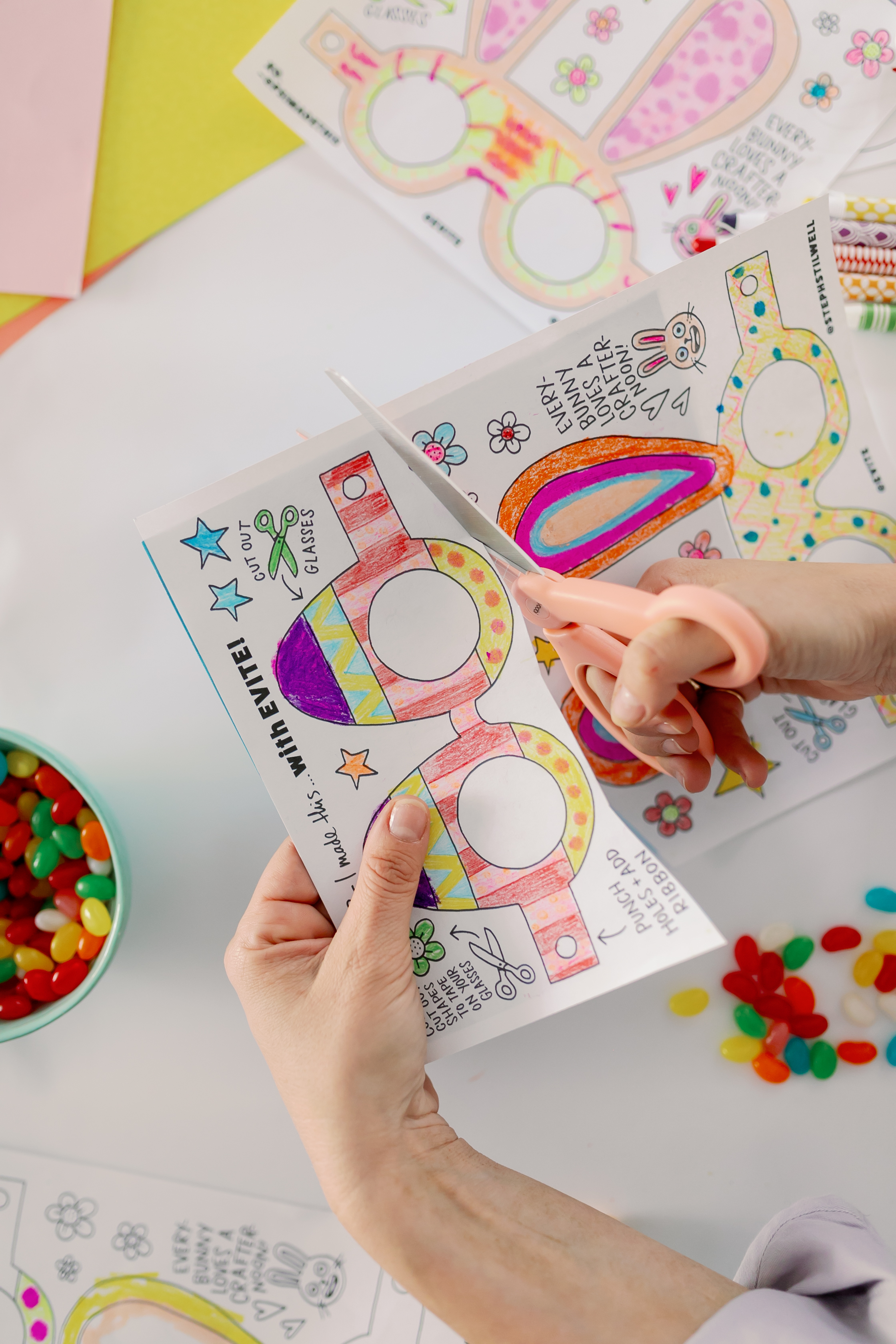A person cutting out the Easter printable.