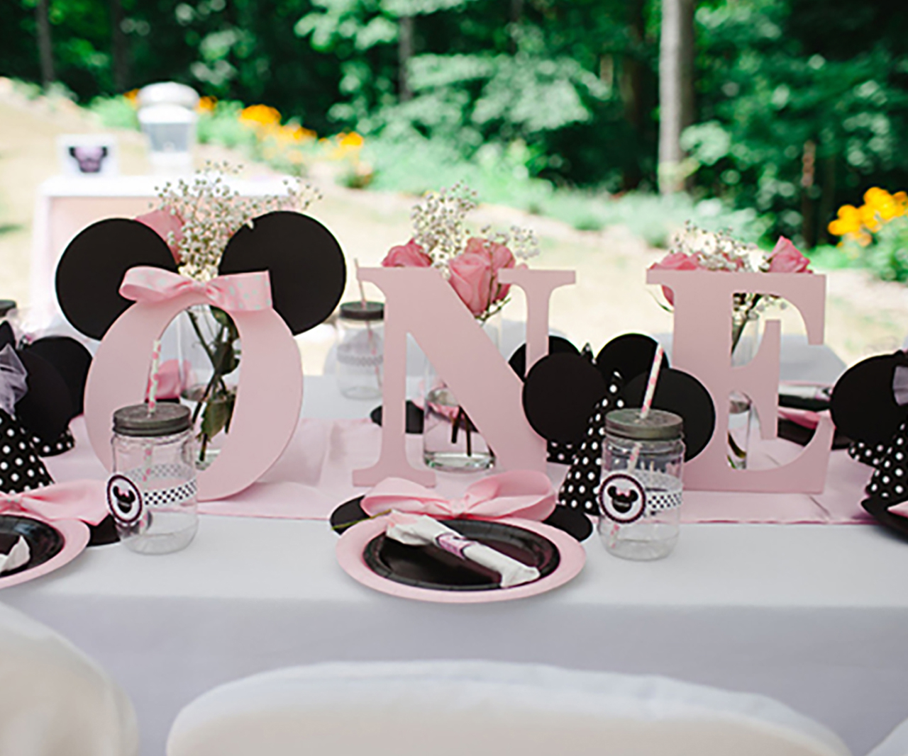 A table decorated in pink mouse tableware and decor.