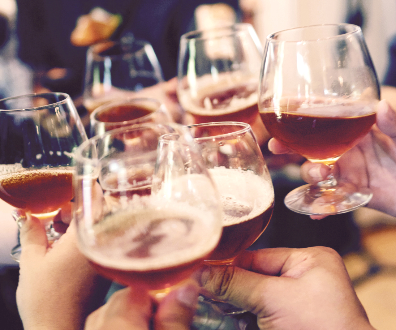 A group of people toasting with craft beer.