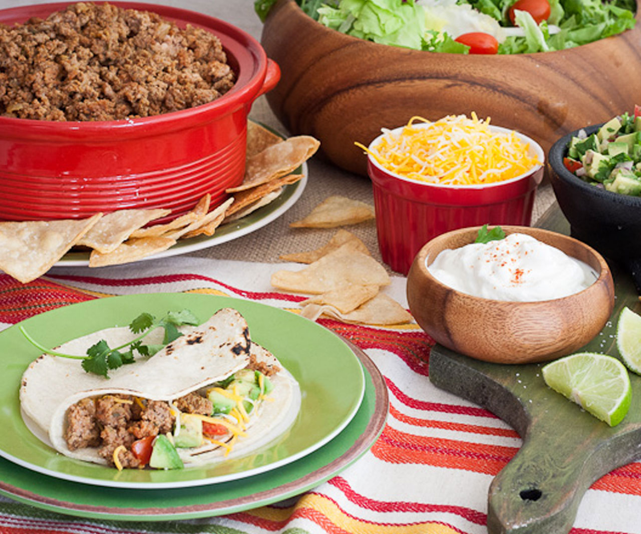 Tacos surrounded by taco ingredients.
