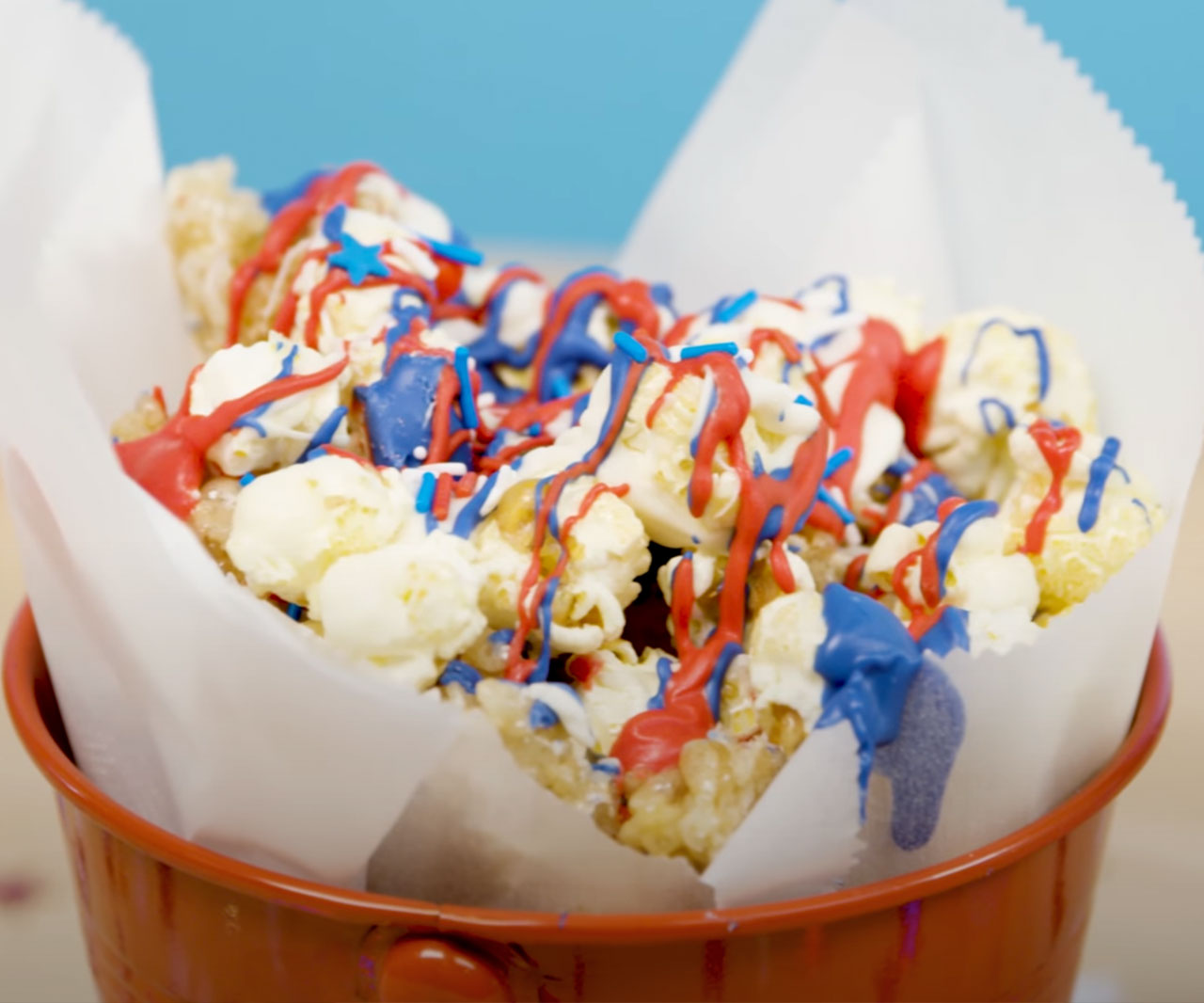Red, white and blue popcorn in a bowl.