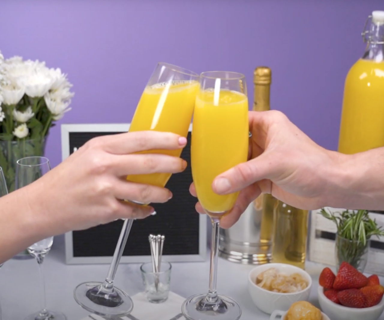 People toasting with mimosas.