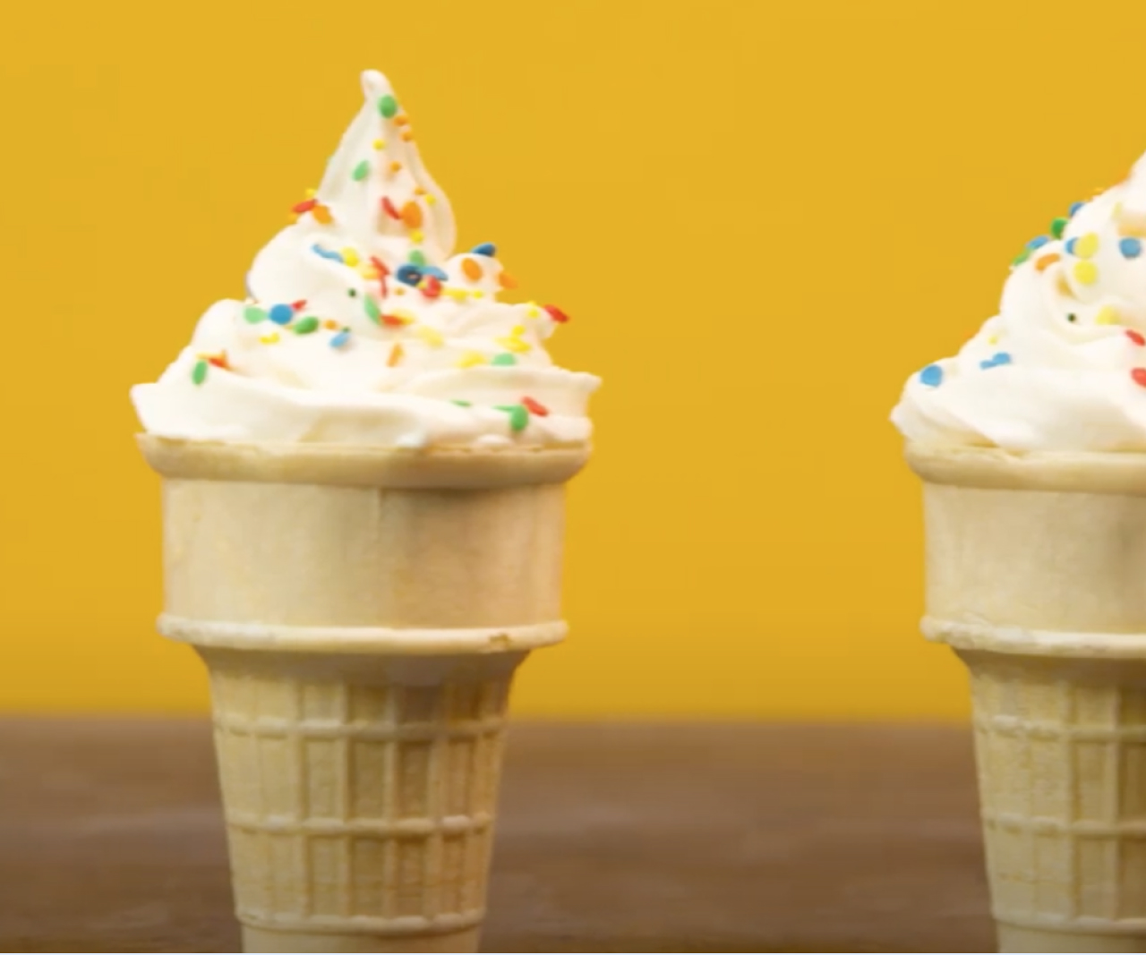 Ice cream cones with frosting on top.