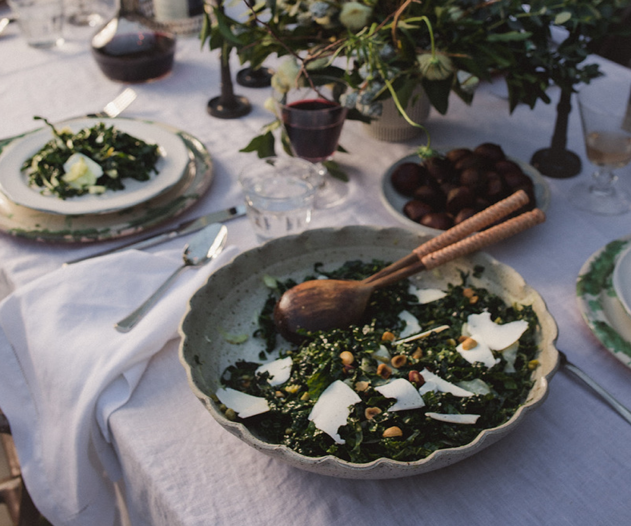 Kale salad in a bowl on a set table.