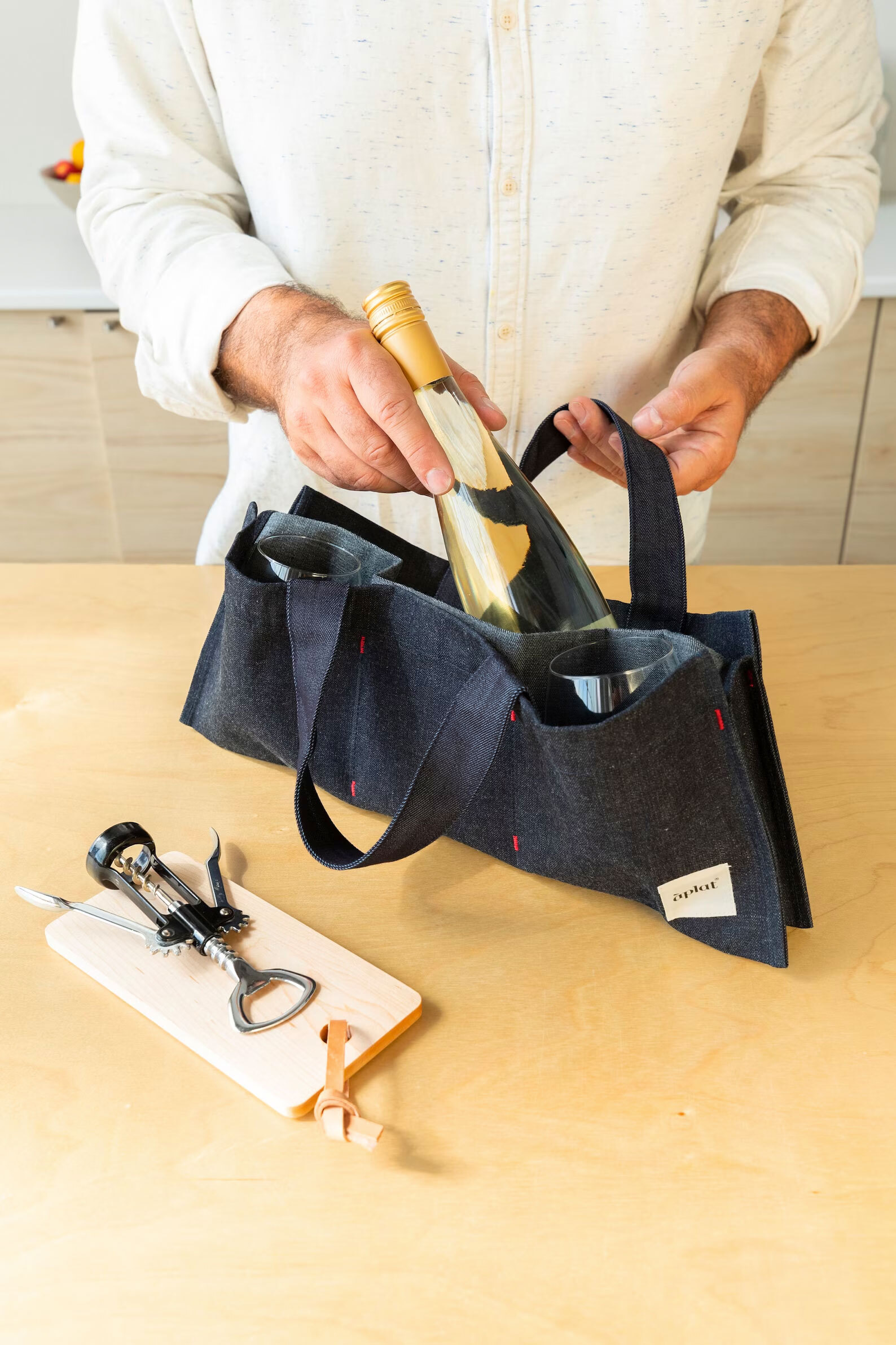 Denim bag for holding wine.