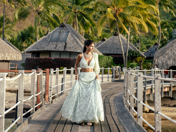 Priya walking down a pier.