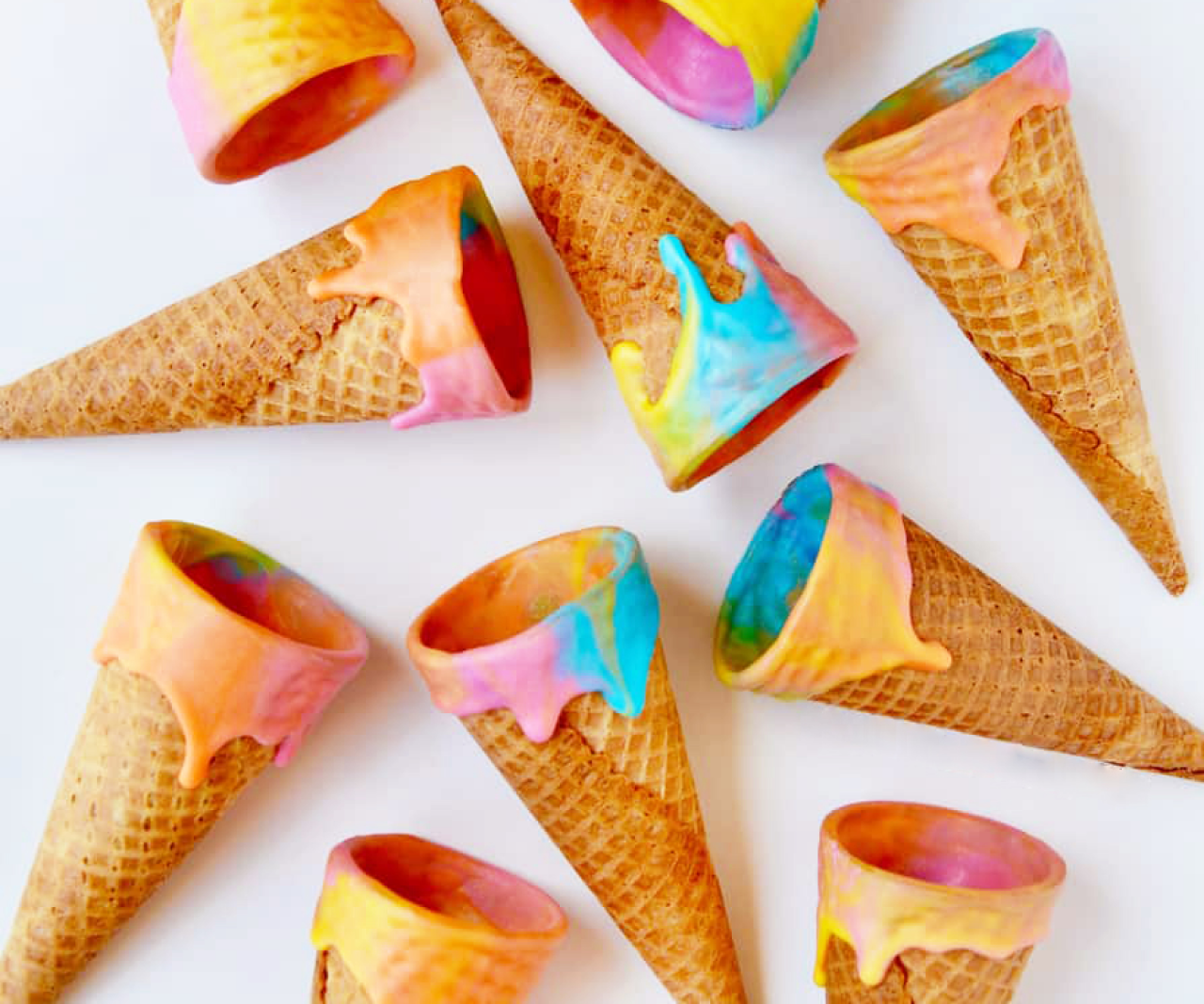 Ice cream cones with colorful coatings on top.