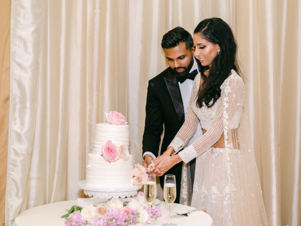 Priya and Sumanth cutting their cake.