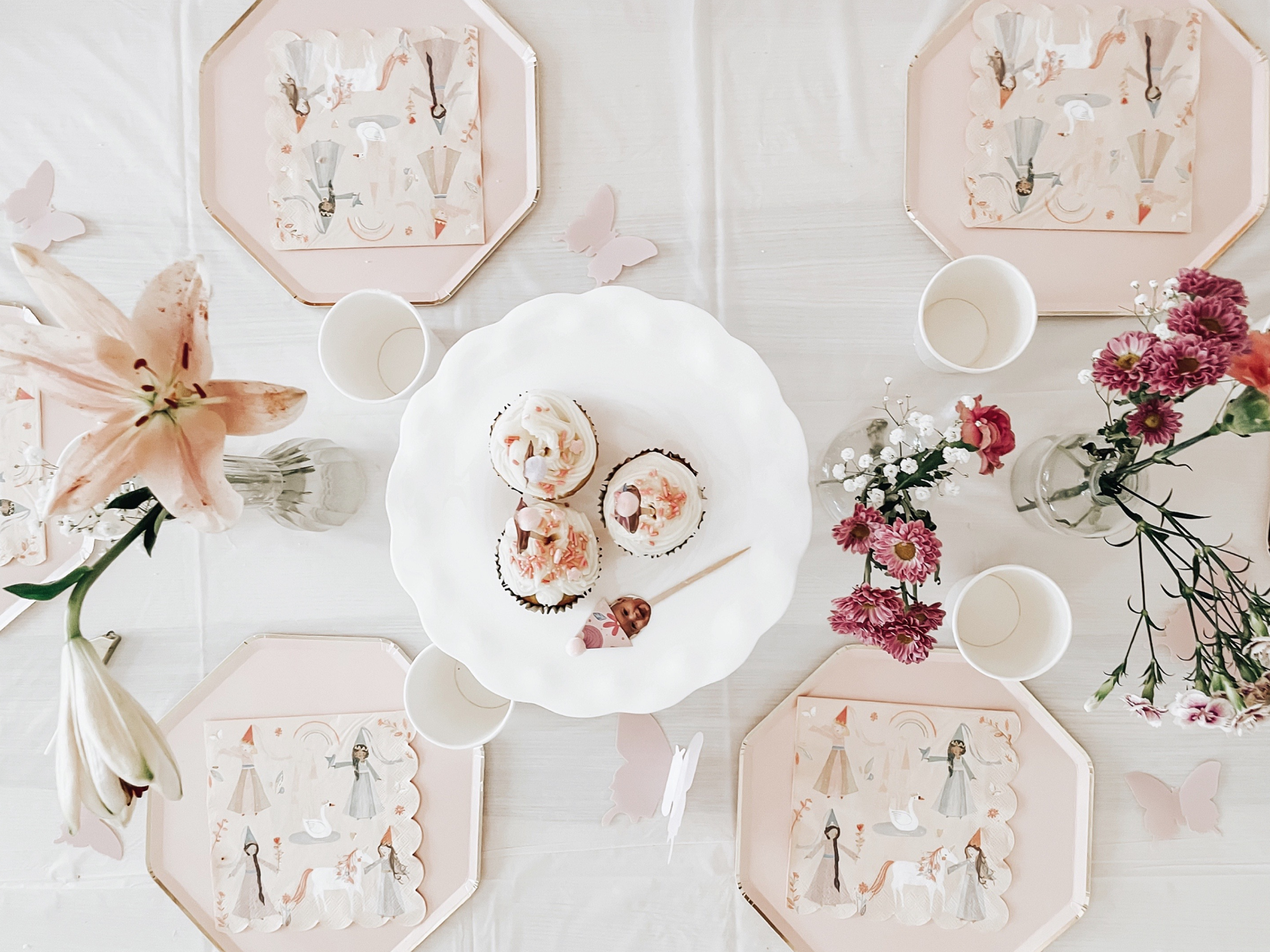 An overhead photo of a pink birthday tablescape for a fairy-themed party.