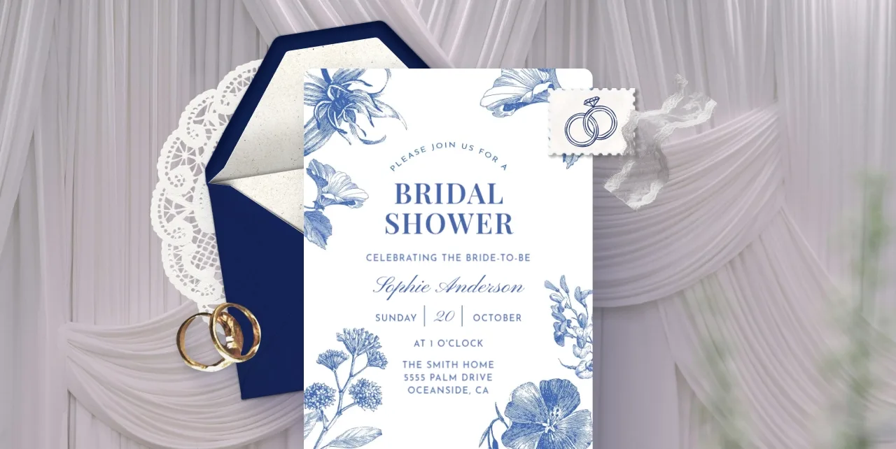 A white Invitation with blue flower drawings throughout. 