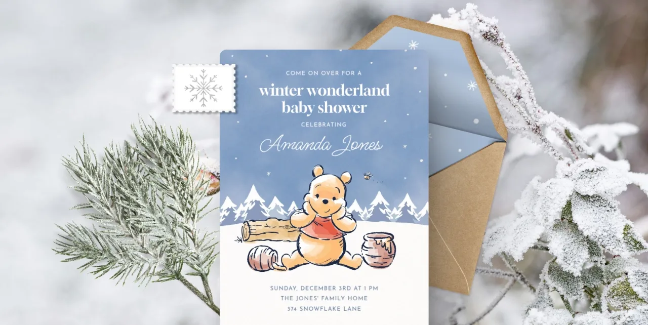 An Invitation showing a white snowy background with a blue sky and a drawing of Winnie the Pooh with honey.  

