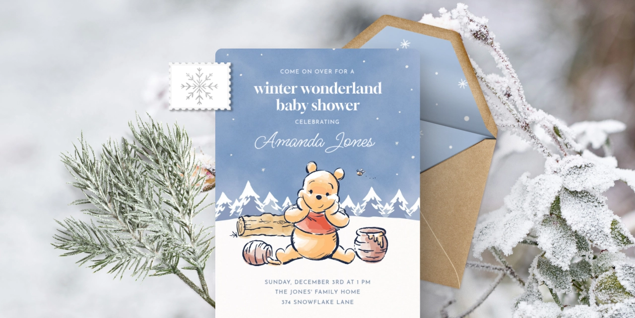 An Invitation showing a white snowy background with a blue sky and a drawing of Winnie the Pooh with honey.  
