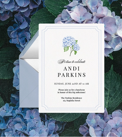 A white graduation party invitation with a watercolor blue hydrangea illustration and a delicate blue border.