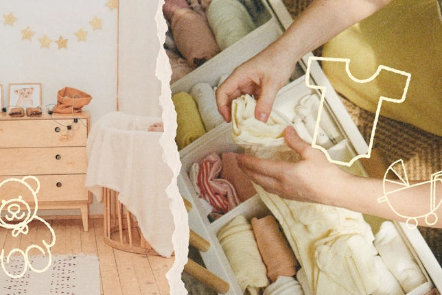 Hands organizing folded baby clothes in a drawer with a cozy nursery in the background.