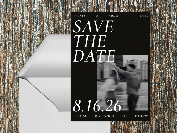 A save-the-date card with an envelope and tinsel backdrop.