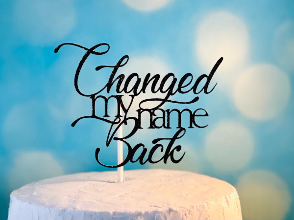Cake topper that says "Changed my name back."