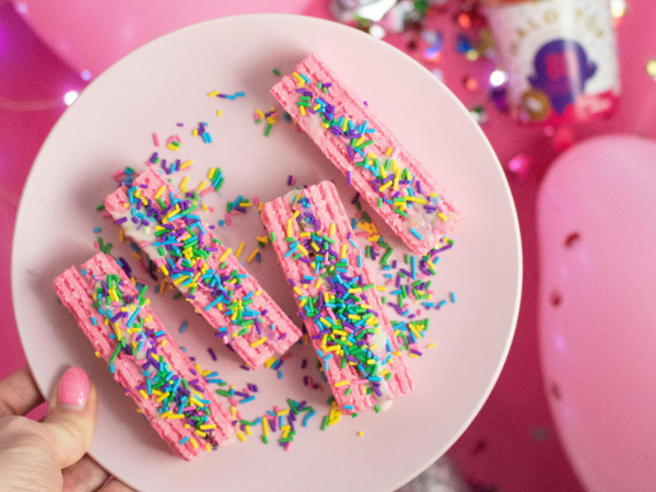 A plate full of sweets and sprinkles.