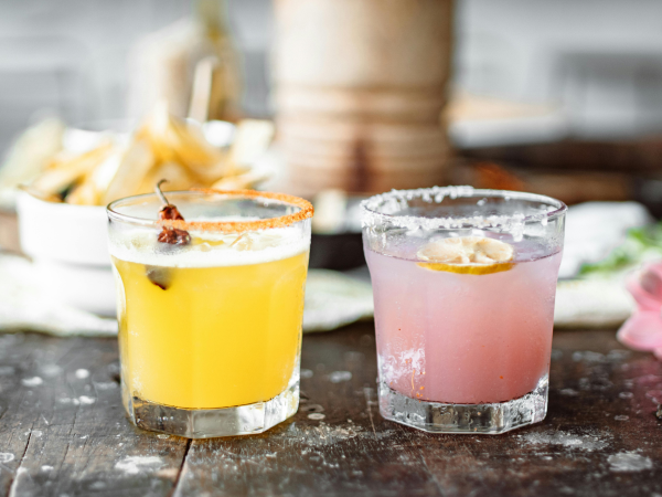 Two fancy cocktails on a table.