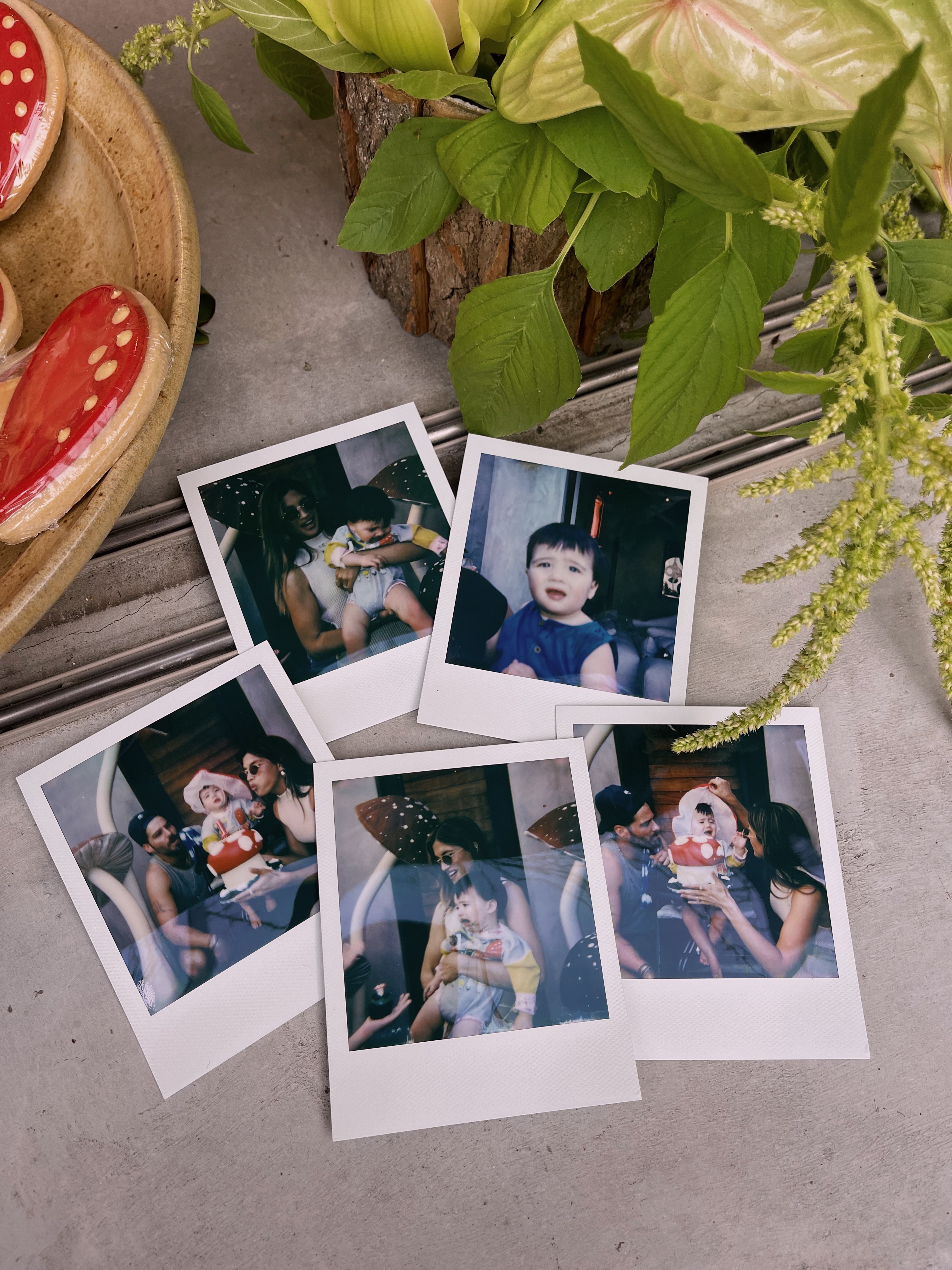 Polaroids taken at the party sit on a table.