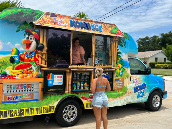 A person ordering at a Kona Ice truck.