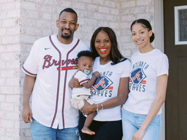 A family smiling for a photo.