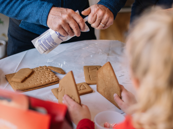 A kid building a gingerbread house.